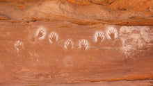 Load image into Gallery viewer, These handprints were created almost 1,000 years ago by blowing a mouthful of paint over the hand. This was most likely part of a puberty ceremony for young men.